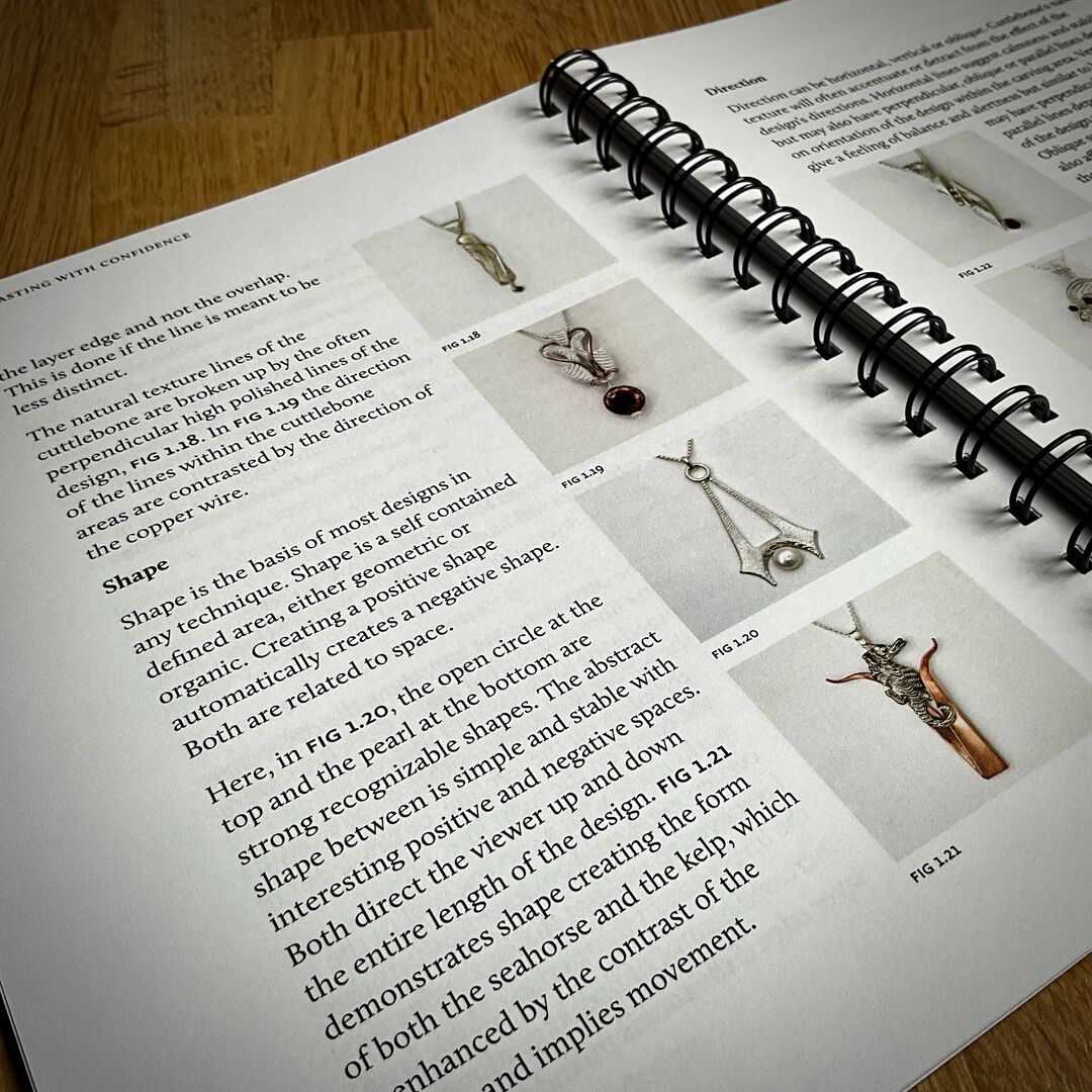 The book has an open spiral binding and shows various images within it with text descriptions about designing jewellery and the principles to consider.