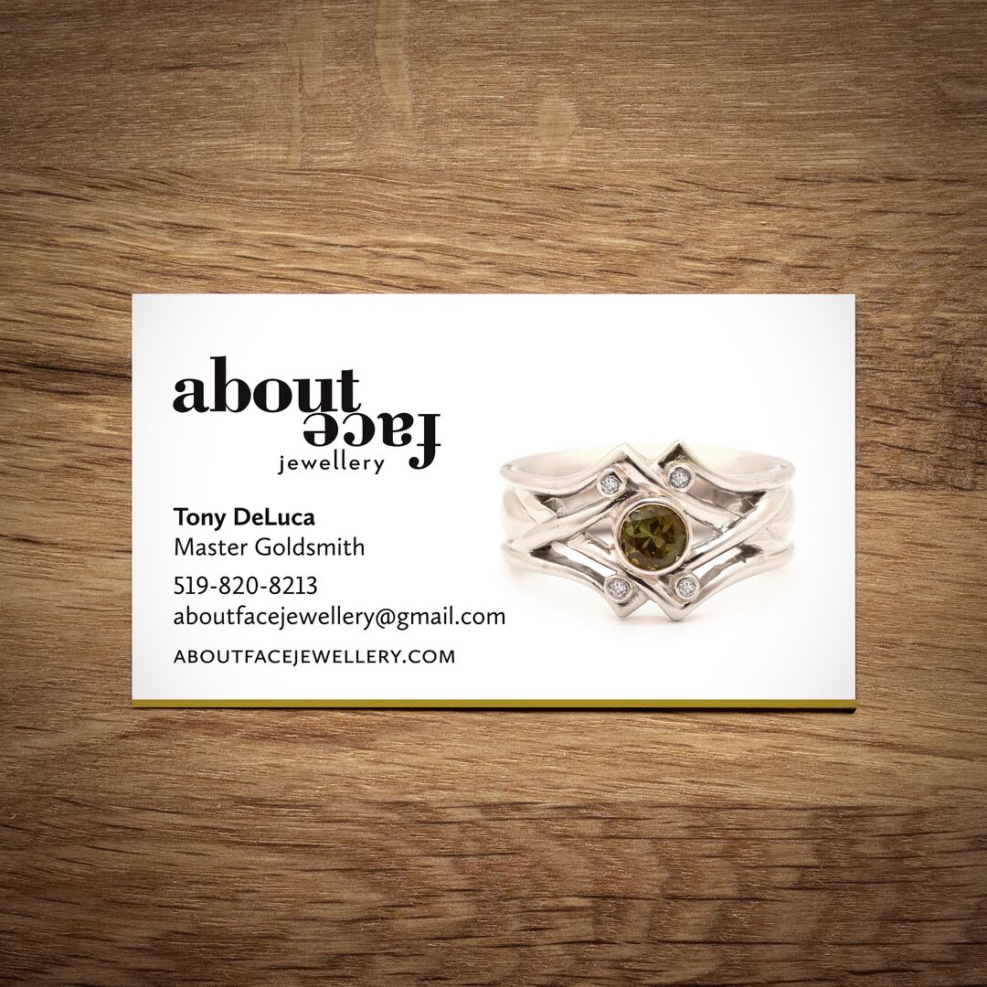 Aboutface Jewellery business card featuring The Kings Cross Ring in silver, with peridot, amethyst, iolite, garnet, diamond on while background